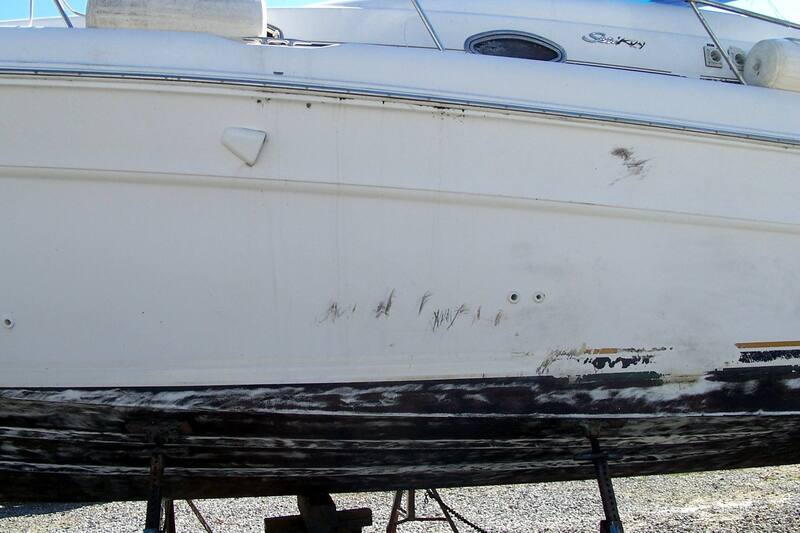 Scuffed Sea Ray hull side before the work